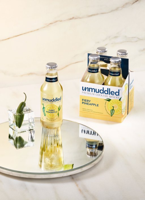 A stylized photo of a 4 pack of Fiery Pineapple Mixers