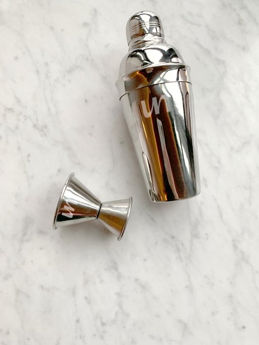 A photo of a Unmuddled branded mixer and jigger